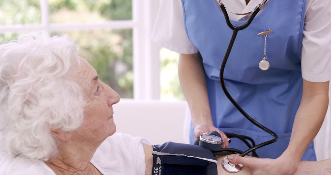 Nurse Measuring Elderly Woman's Blood Pressure in Medical Office - Free Images, Stock Photos and Pictures on Pikwizard.com