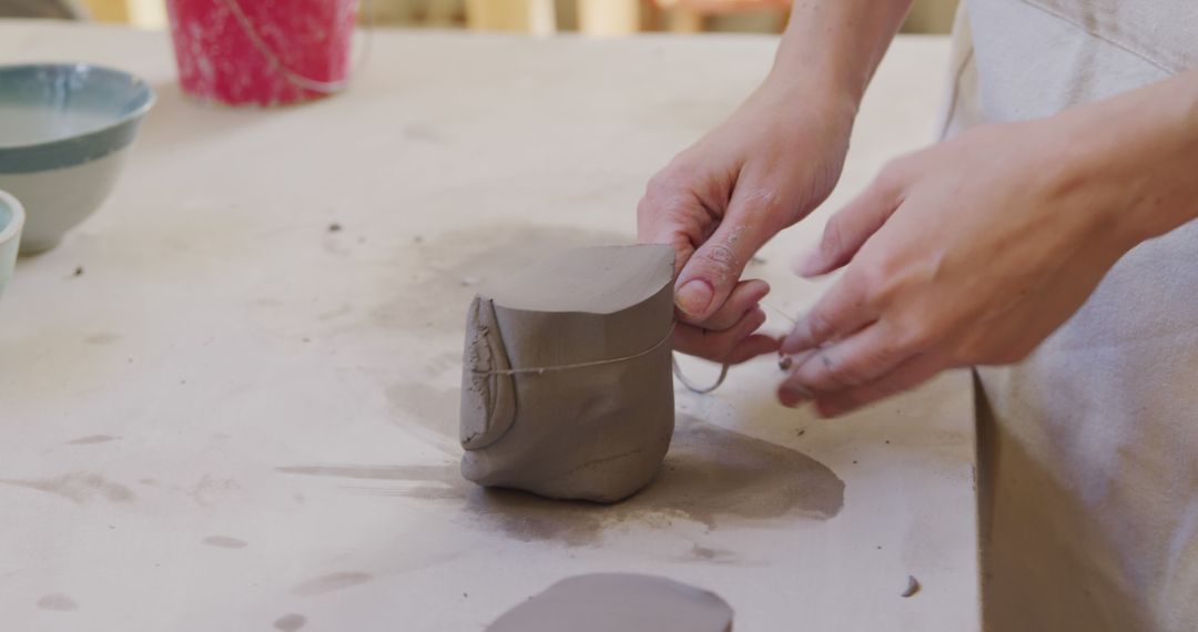 Potter Shaping Clay with Wire Tool in Studio - Free Images, Stock Photos and Pictures on Pikwizard.com