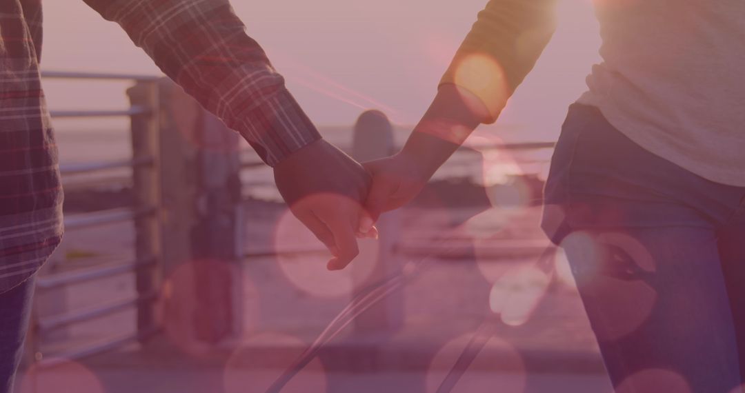 Couple Holding Hands at Sunset with Artistic Light Effects