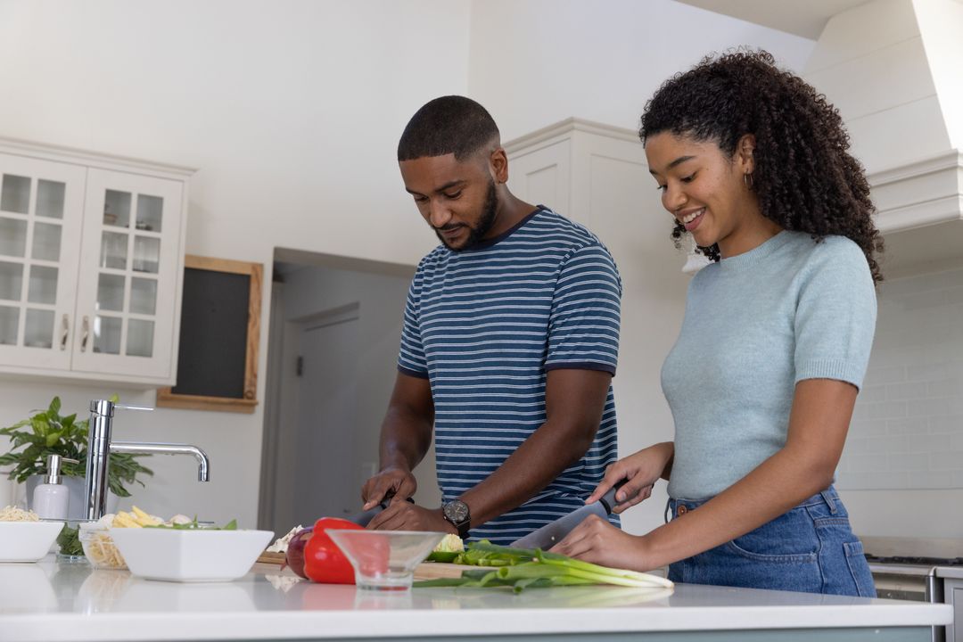 Joyful Couple Chopping Vegetables in Modern Kitchen