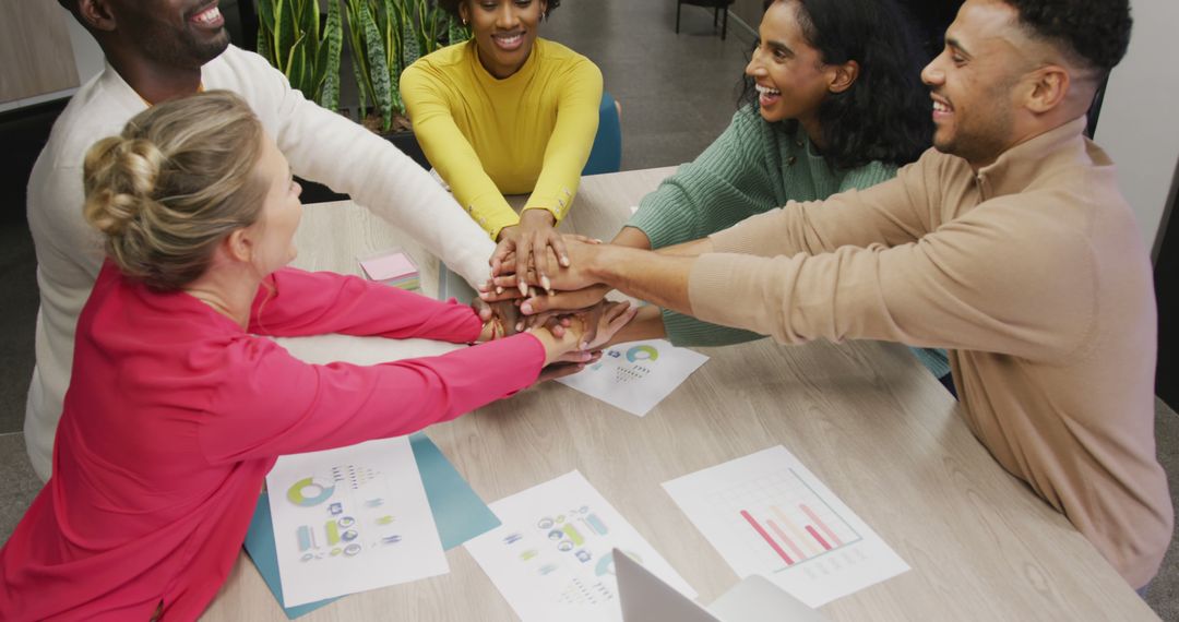 Diverse Business Team Celebrating Success with Group Hand Stack