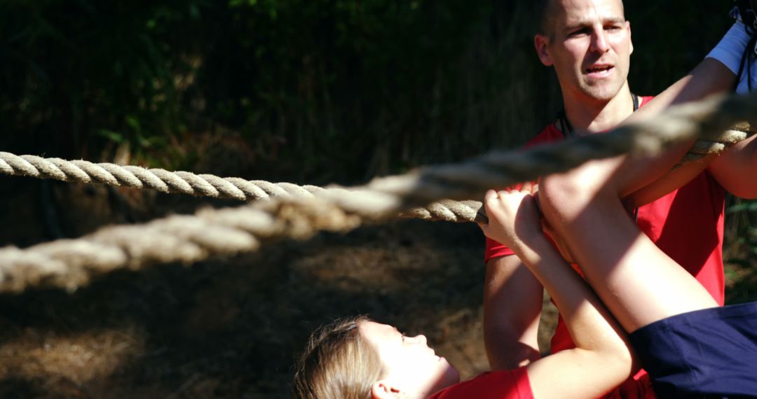 Trainer Assisting Kids During Intense Obstacle Course Challenge - Free Images, Stock Photos and Pictures on Pikwizard.com