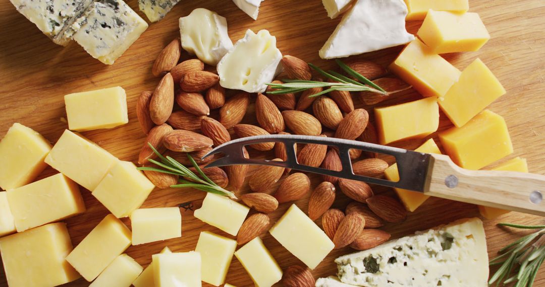 Assorted Cheeses with Almonds on Wooden Board - Free Images, Stock Photos and Pictures on Pikwizard.com