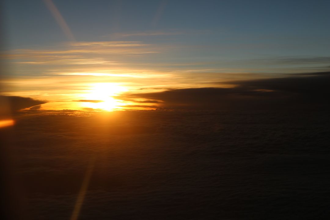 Spectacular Sunset Above Clouds Captured From Airplane Window - Free Images, Stock Photos and Pictures on Pikwizard.com