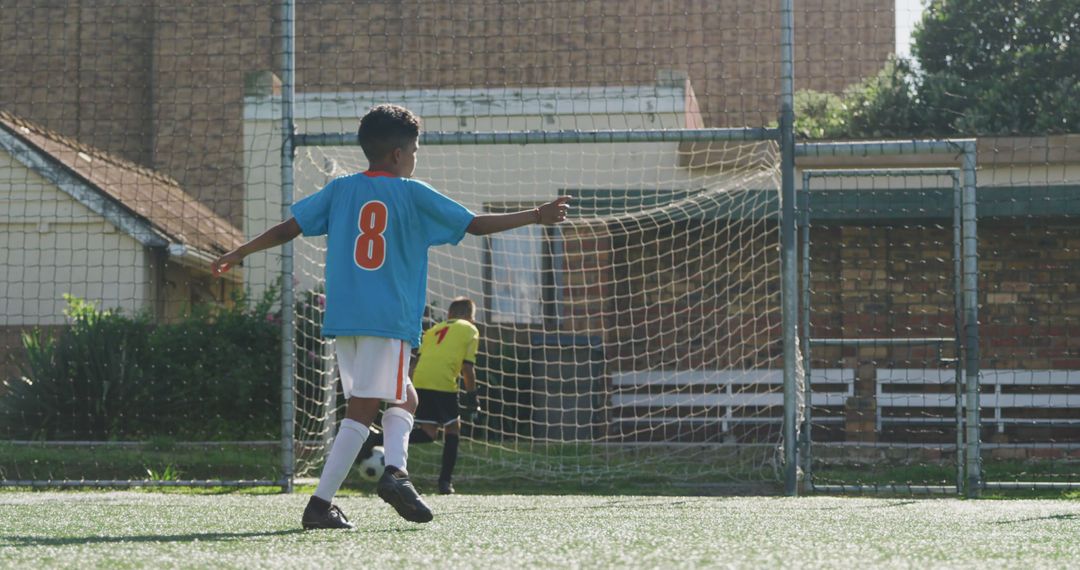 Young Soccer Player Scoring Goal on Sunny Day - Free Images, Stock Photos and Pictures on Pikwizard.com