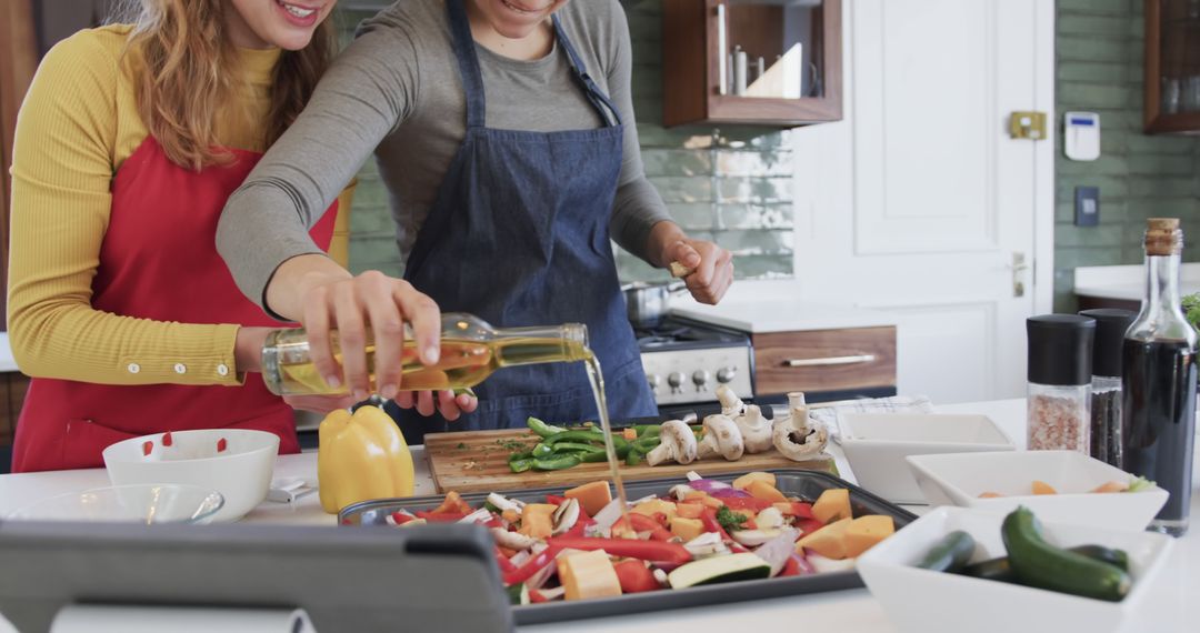 Two Women in Kitchen Preparing Mixed Vegetables for Baking - Free Images, Stock Photos and Pictures on Pikwizard.com