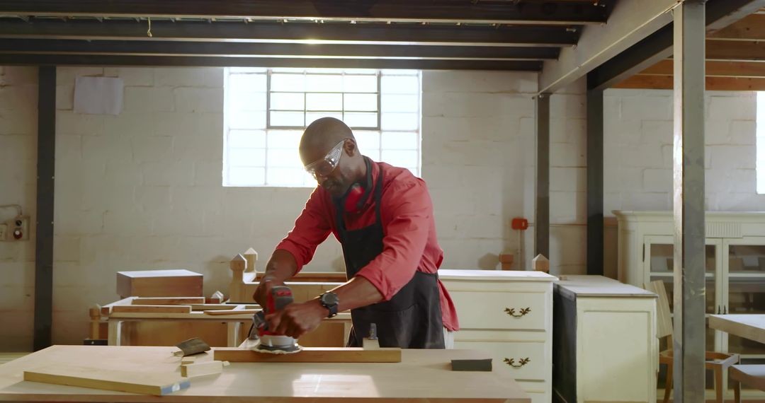 Experienced carpenter sanding wooden plank in rustic workshop, woodworking craftsmanship