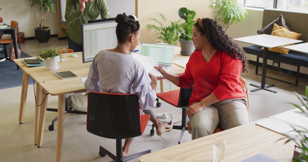 Coworkers Collaborating in Modern Open Office Environment