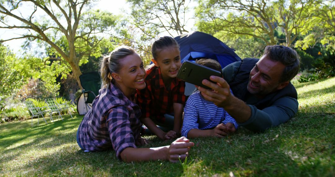 Family Enjoying Camping Trip Taking Selfie in Park - Free Images, Stock Photos and Pictures on Pikwizard.com