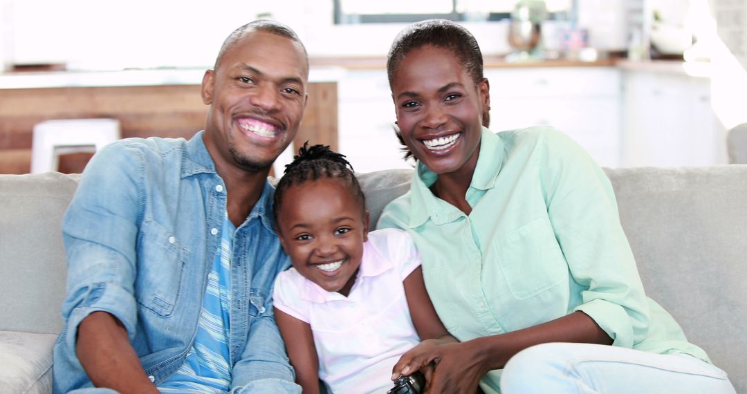 Smiling African American Family Sitting Together on Couch at Home - Free Images, Stock Photos and Pictures on Pikwizard.com