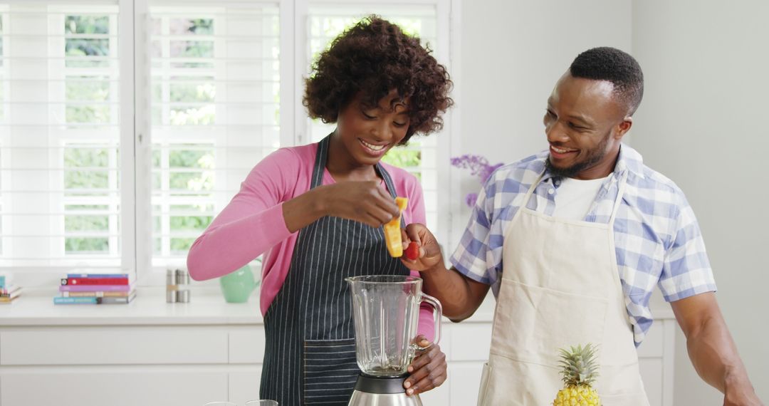 Happy couple preparing smoothie in bright modern kitchen - Free Images, Stock Photos and Pictures on Pikwizard.com