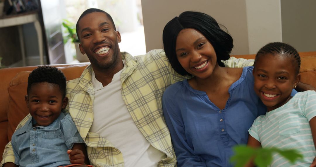 Happy African American Family Smiling Together on Couch - Free Images, Stock Photos and Pictures on Pikwizard.com