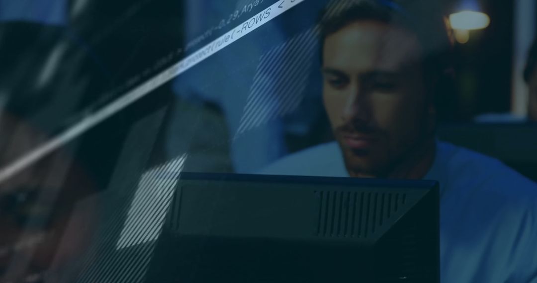 Businessman Analyzing Financial Data on Computer at Night