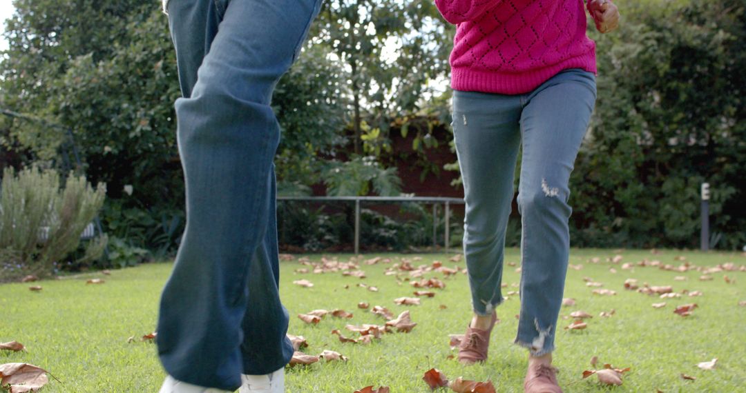 Mother and Son Enjoying Football in Autumn Garden