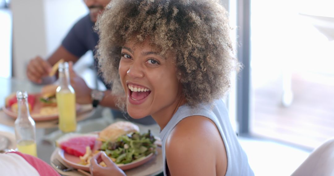 Joyful Woman Dining with Friends Enjoying Meal Together