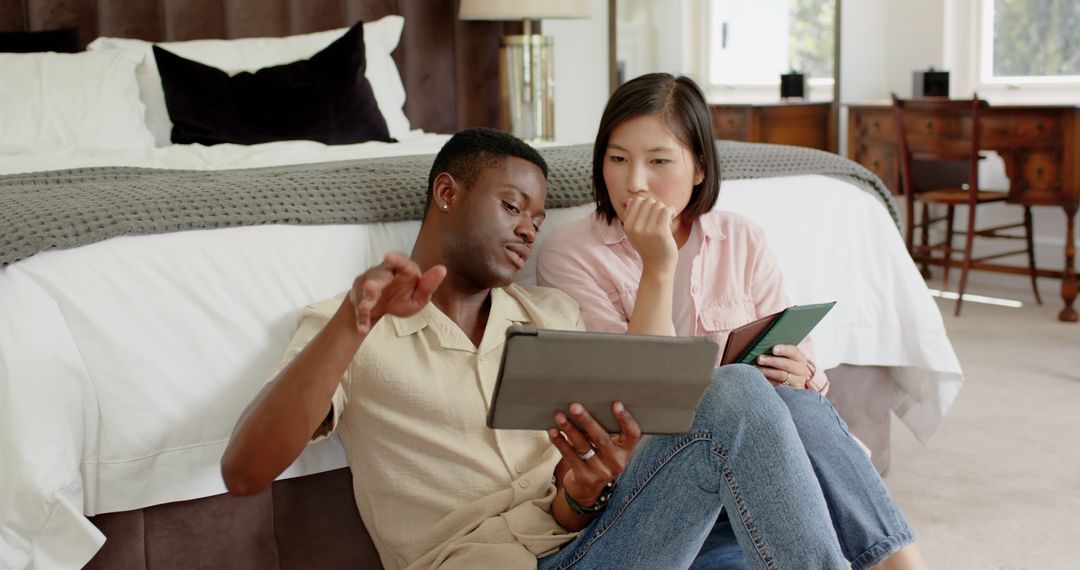 Young Adults Discussing Ideas Using Tablet and Smartphone at Home