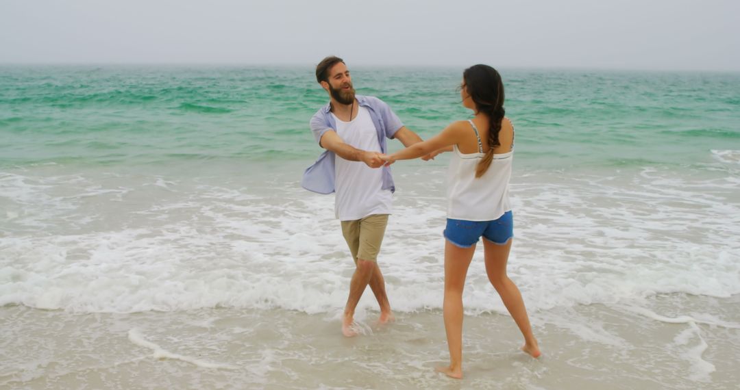 Joyful Couple Playing Together on Shoreline
