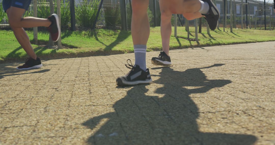 Close-up of People Jogging on Outdoor Path - Free Images, Stock Photos and Pictures on Pikwizard.com