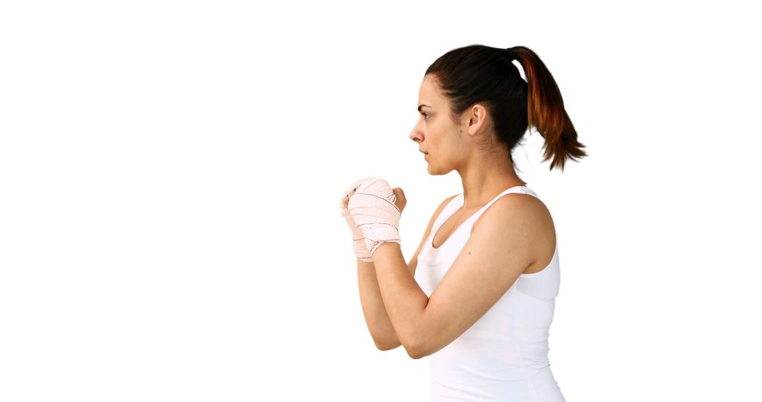 Determined Female Boxer in Training Stance with Wrapped Hands - Free Images, Stock Photos and Pictures on Pikwizard.com