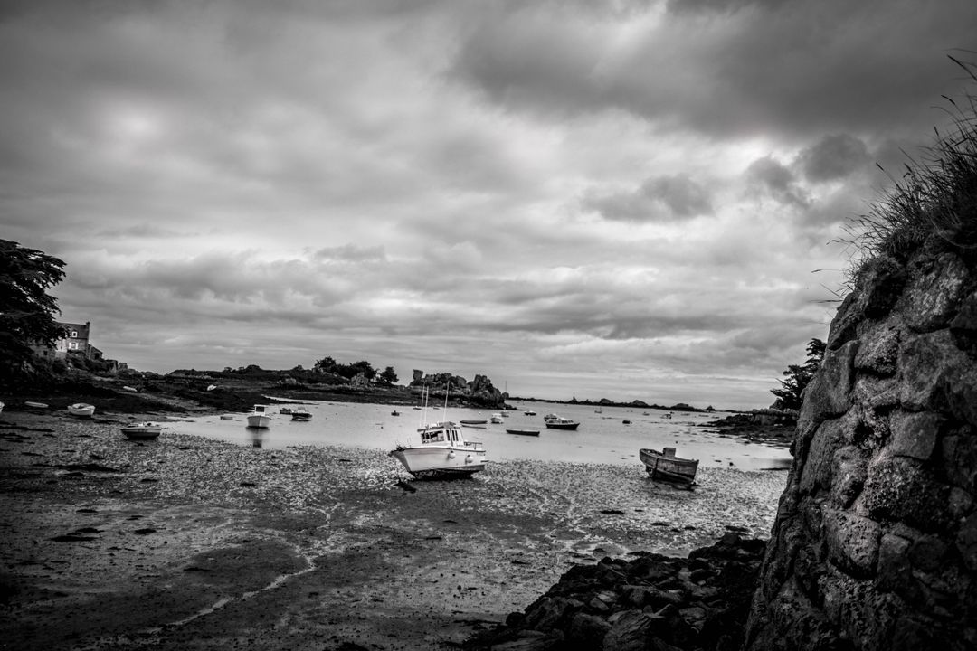 Black And White Landscape Showing Boats On Rocky Shoreline - Free Images, Stock Photos and Pictures on Pikwizard.com
