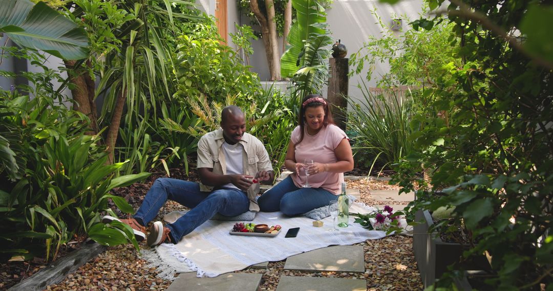 Couple Enjoying Outdoor Picnic in Lush Garden