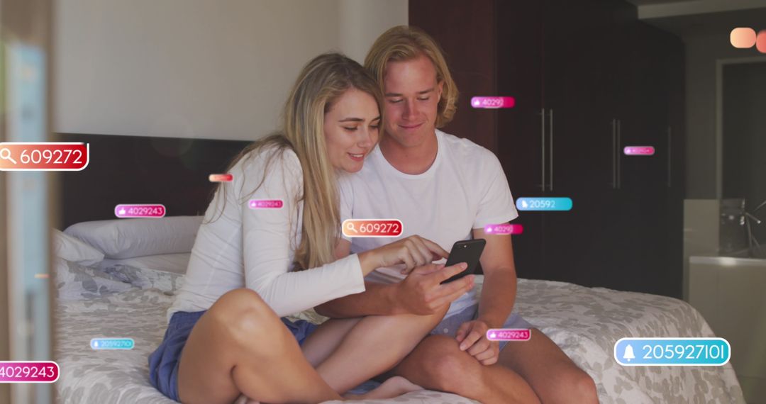 Couple Engaging with Social Media Icons Overlay on Bed