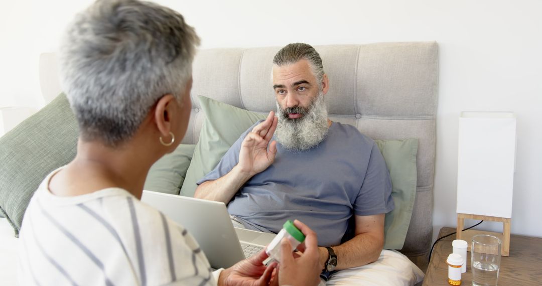 Senior Patient Consulting with Caregiver About Medications at Home