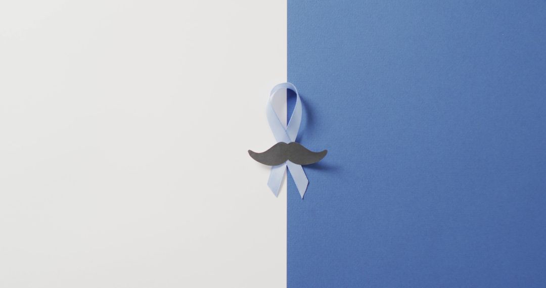 Image of paper moustache and pale blue prostate cancer ribbon on white and blue background - Free Images, Stock Photos and Pictures on Pikwizard.com