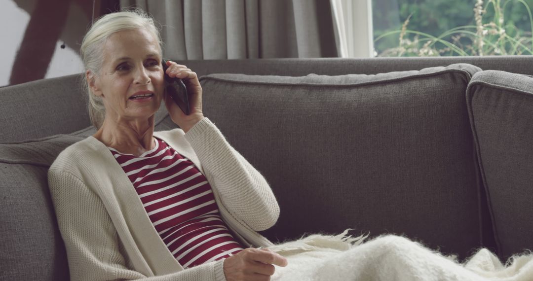 Senior Woman Speaking on Phone While Relaxing at Home - Free Images, Stock Photos and Pictures on Pikwizard.com