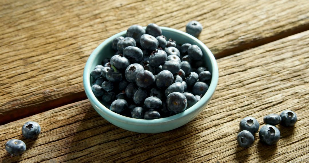 Fresh Blueberries in Blue Bowl on Rustic Wooden Table - Free Images, Stock Photos and Pictures on Pikwizard.com