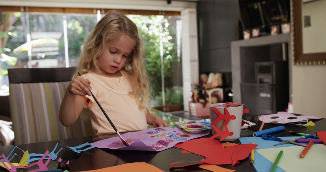 Young Girl Creating Colorful Paper Art Crafts on Table - Free Images, Stock Photos and Pictures on Pikwizard.com