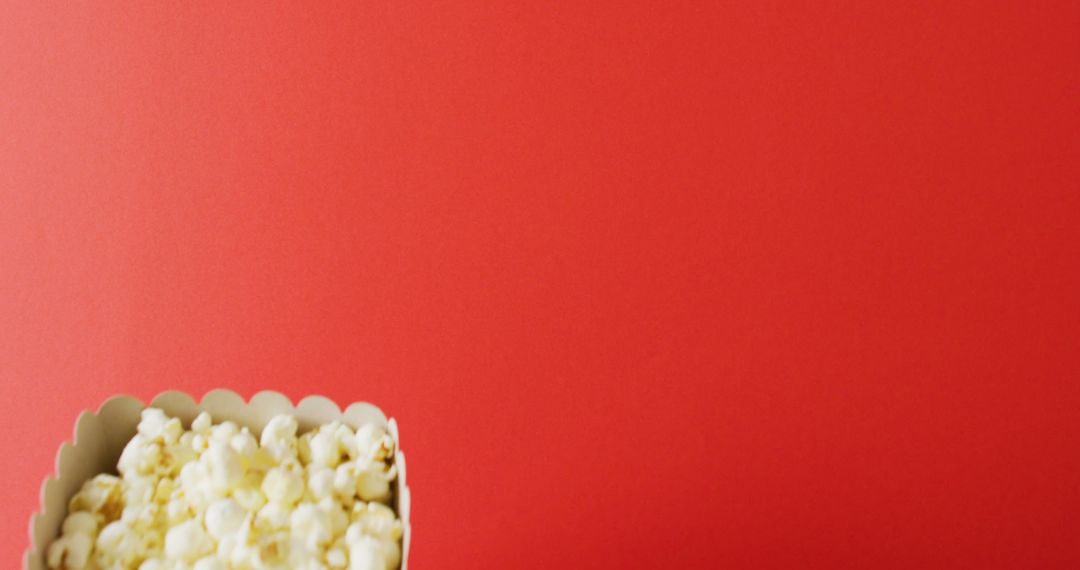 Close-Up of Popcorn on Bold Red Background for Creative Use - Free Images, Stock Photos and Pictures on Pikwizard.com