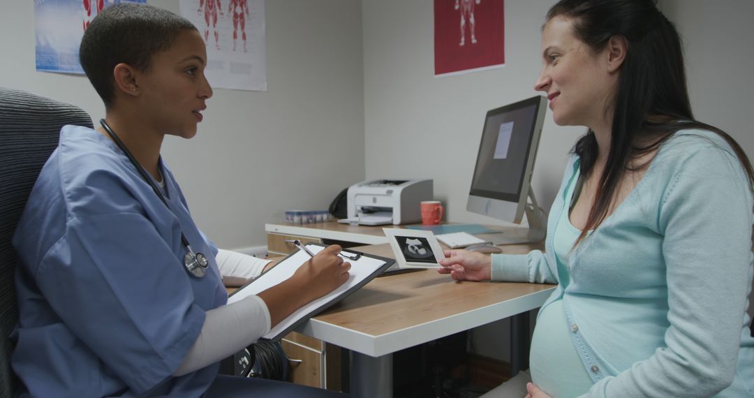 Pregnant Woman Receiving Ultrasound Results from Doctor in Clinic - Free Images, Stock Photos and Pictures on Pikwizard.com