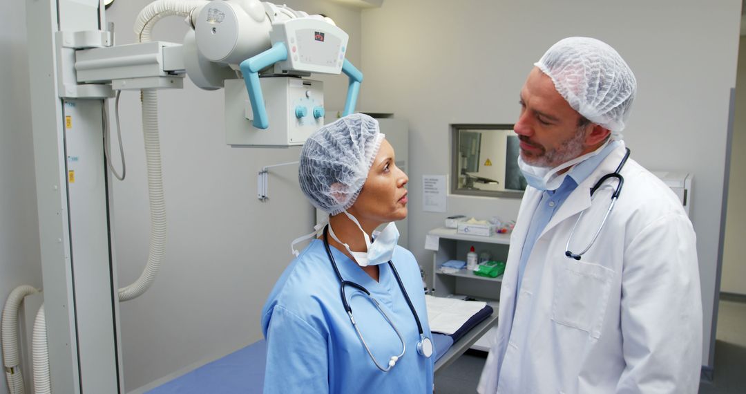 Medical Professionals Discussing X-Ray Results in Hospital Room - Free Images, Stock Photos and Pictures on Pikwizard.com