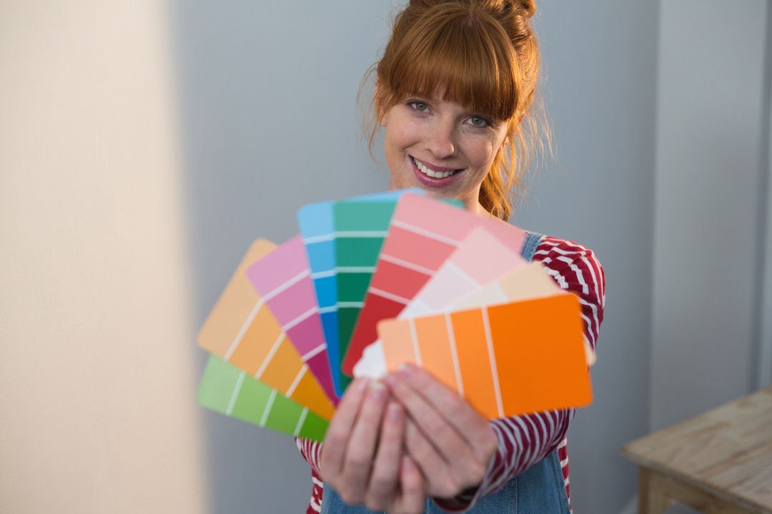 Female painter holding color palletes at home - Free Images, Stock Photos and Pictures on Pikwizard.com