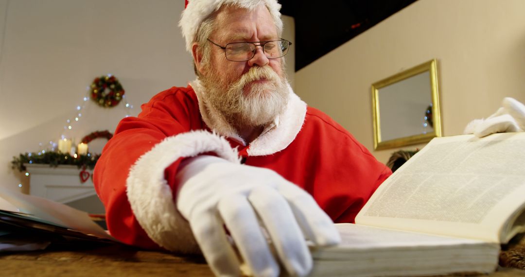 Santa Claus Reading Large Book in Festive Home Interior - Free Images, Stock Photos and Pictures on Pikwizard.com