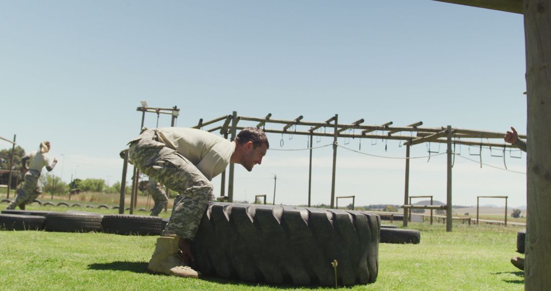 Soldier Flip Tractor Tire on Obstacle Course for Strength Training