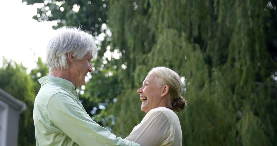 Senior Couple Laughing Together in Park - Free Images, Stock Photos and Pictures on Pikwizard.com