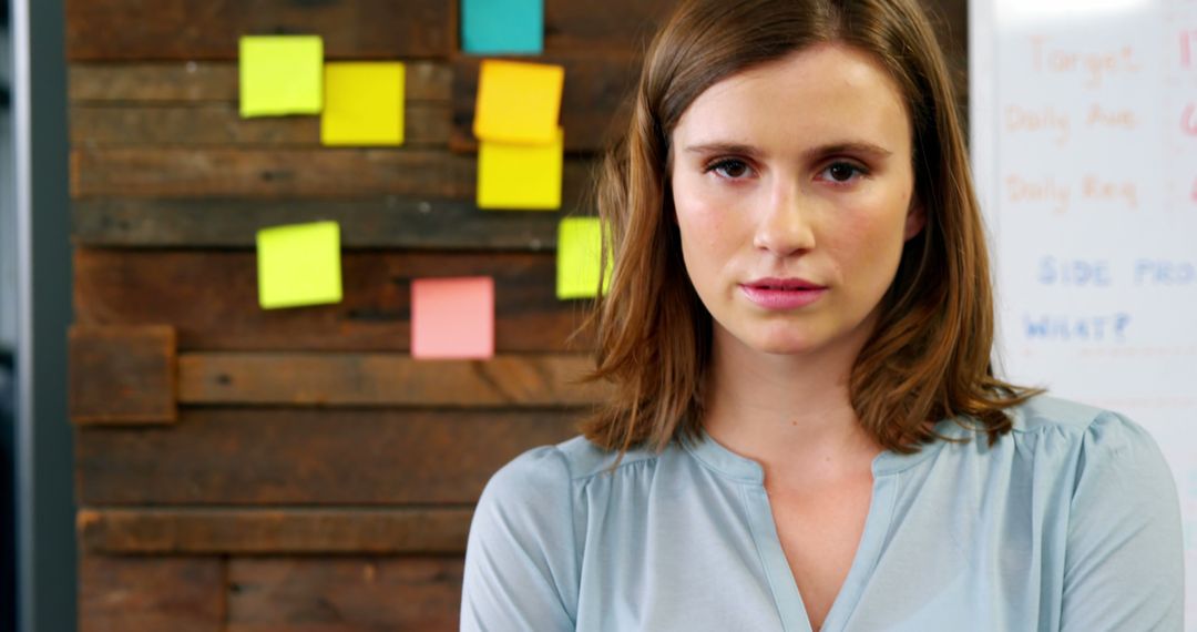 Confident Businesswoman Posing in Creative Office Space with Wooden Wall and Sticky Notes - Free Images, Stock Photos and Pictures on Pikwizard.com