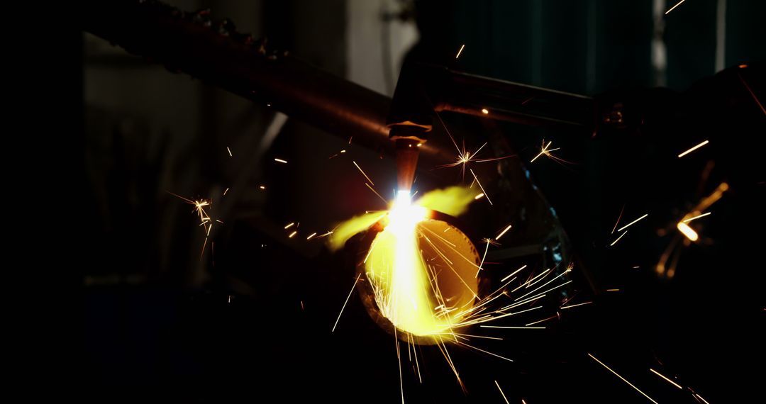 Welder Welding Metal with Bright Sparks in Dark Workshop - Free Images, Stock Photos and Pictures on Pikwizard.com