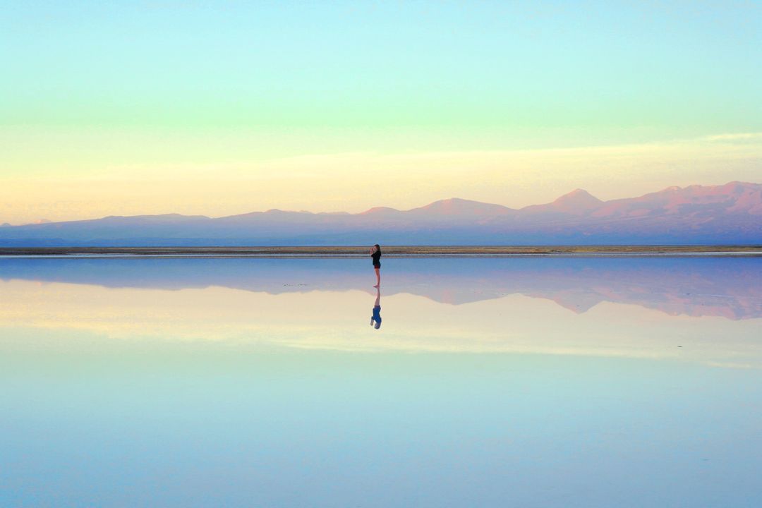 Solitary Person Reflecting in Vast Salt Flat Landscape at Dusk - Free Images, Stock Photos and Pictures on Pikwizard.com