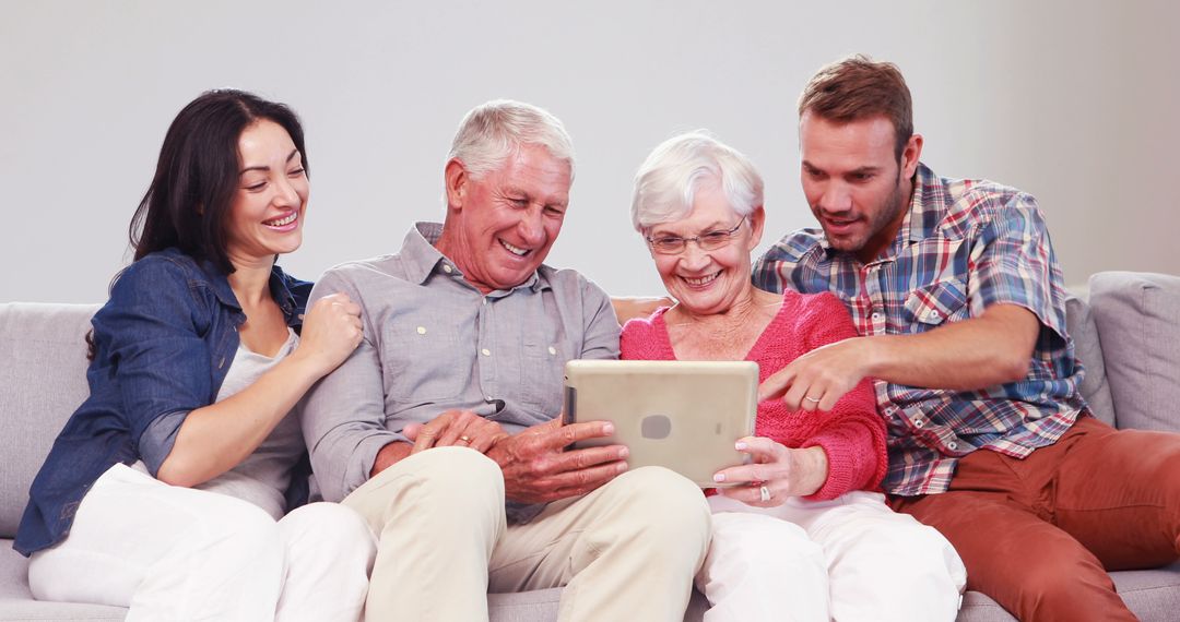 Multigenerational Family Using Tablet on Cozy Couch