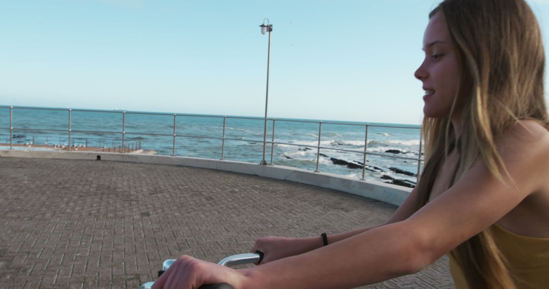 Woman Enjoying Bicycle Ride by Seaside - Free Images, Stock Photos and Pictures on Pikwizard.com