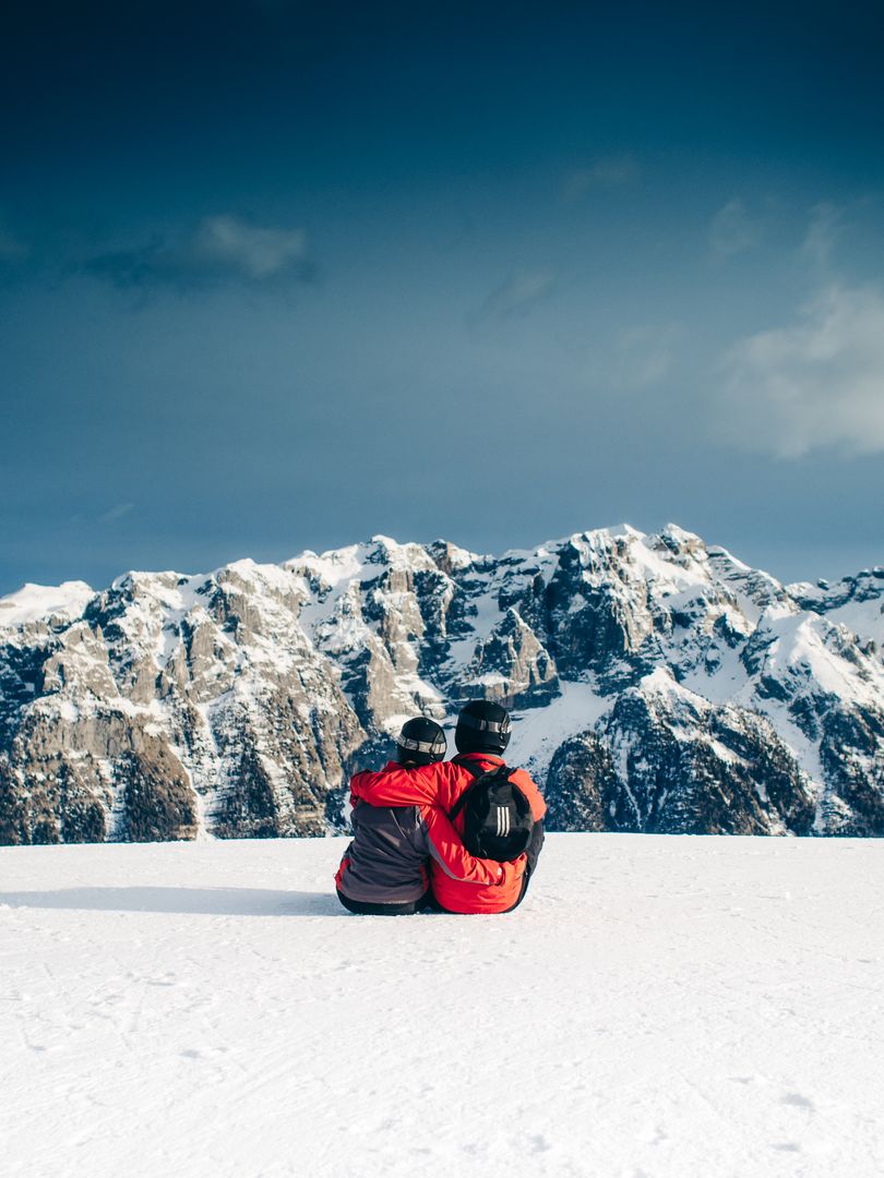 Couple Embracing on Snowy Mountain with Scenic View - Free Images, Stock Photos and Pictures on Pikwizard.com
