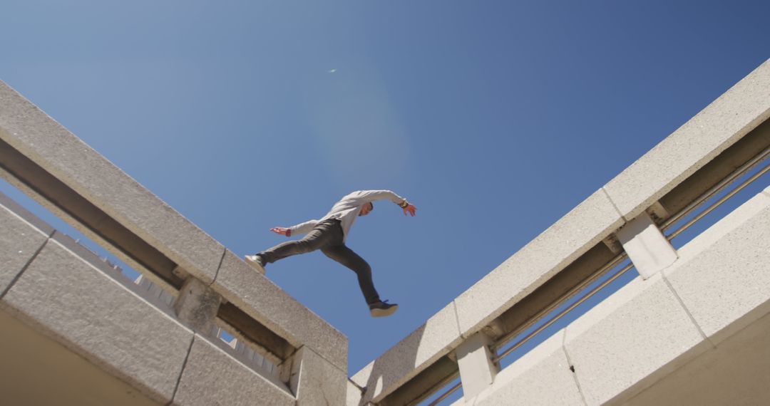 Man Performing Parkour Jumping Between Buildings in Urban Setting - Free Images, Stock Photos and Pictures on Pikwizard.com