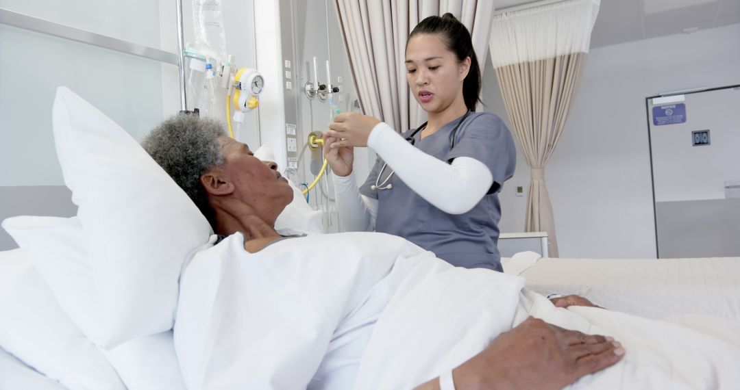 Nurse Treating Elderly Patient in Modern Hospital Room - Free Images, Stock Photos and Pictures on Pikwizard.com