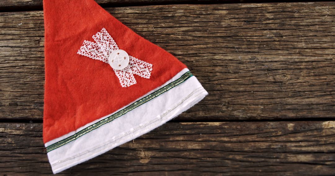 Festive Christmas Hat on Rustic Wooden Background - Free Images, Stock Photos and Pictures on Pikwizard.com