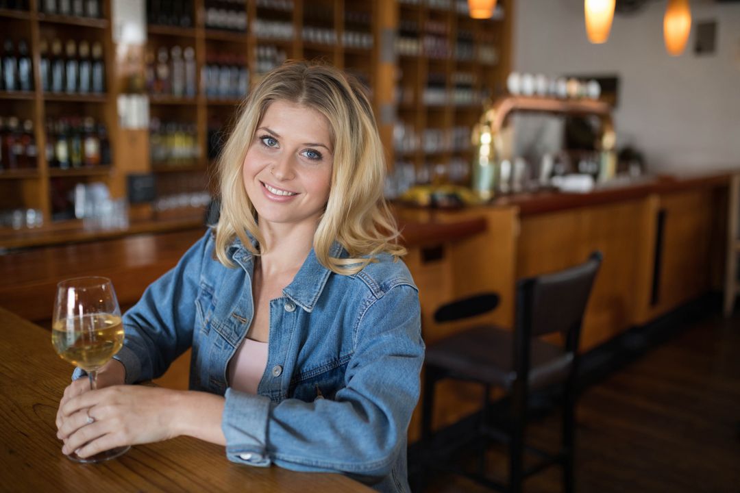 Smiling Woman Enjoying Wine at Elegant Bar Counter