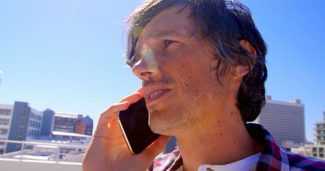 Caucasian Man Talking on Phone in Urban Cityscape