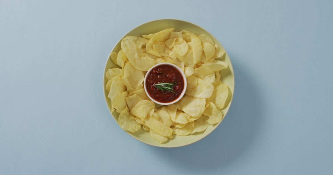 Close up of potato chips in a bowl with sauce on blue surface - Free Images, Stock Photos and Pictures on Pikwizard.com